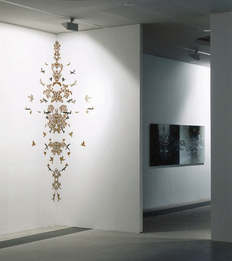 Installation view of the exhibition, Mnemonic II, hand cut sticker ornament on wall, size: 250 x 70, Replica I, c-print, size: 90 x 260 cm
